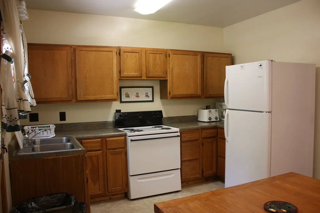 Kitchen with oak cabinets, white range and refrigerator