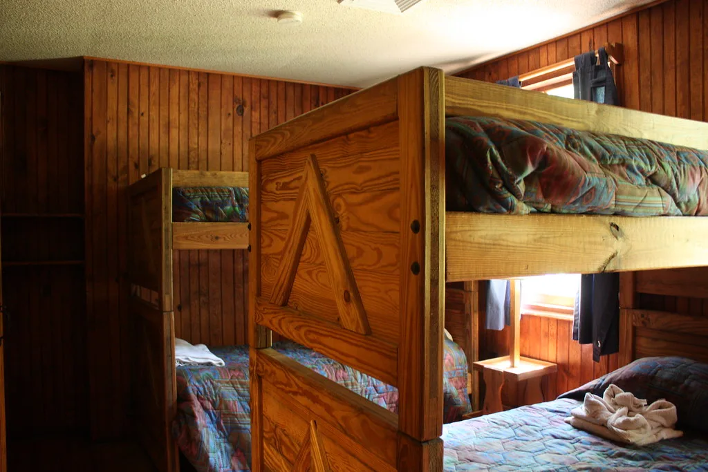 Bunk room with wooden bunk beds in a pine-panelled room