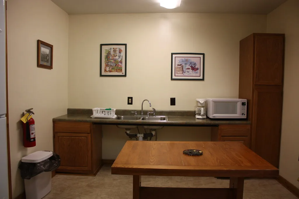 Kitchenette with a counter, microwave and small table